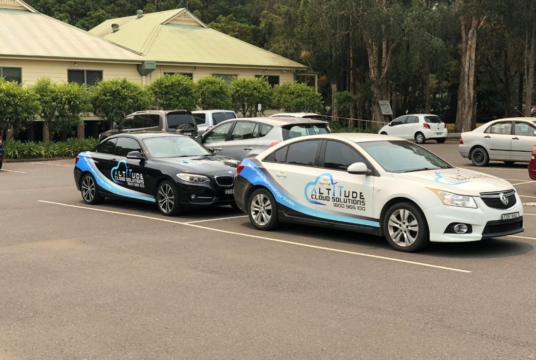 Two Altitude Cloud Solutions branded cars parked together