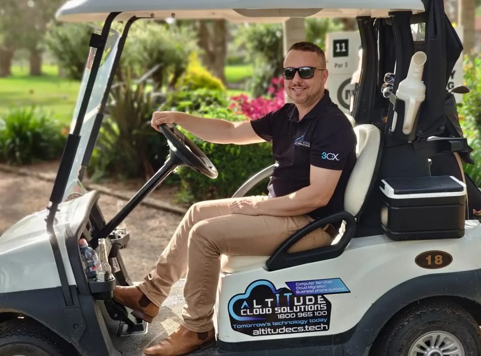 ACS team member in a branded golf cart at a local golf club