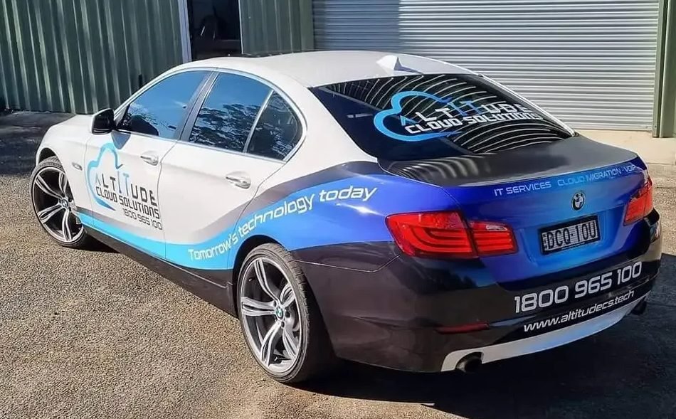 Rear of an ACS branded car showing the 1800 965 100 phone number